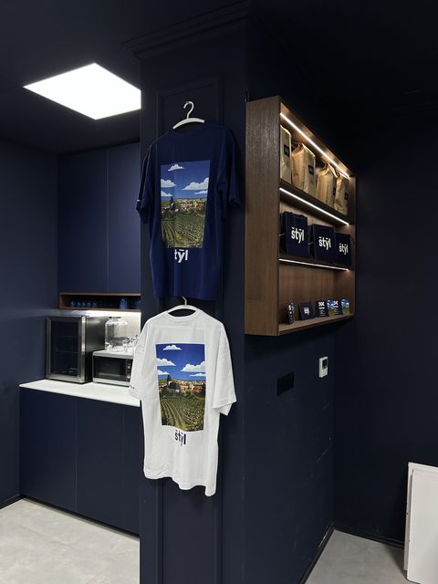 Štýl T-shirts and products on the barbershop wall